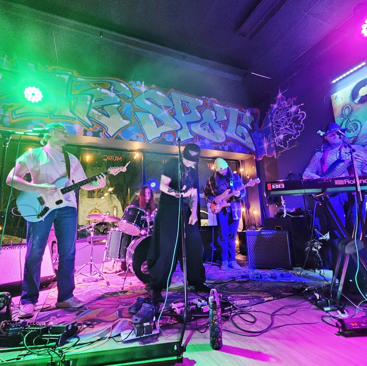 Live band performing on stage at The Spot