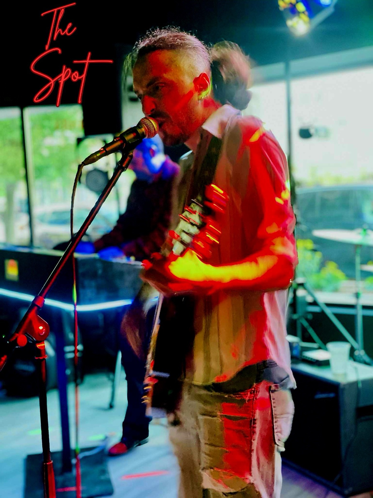 Solo performer on stage at The Spot